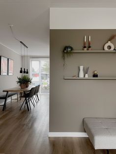 a living room filled with furniture next to a wooden floor