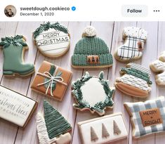 decorated christmas cookies are displayed on a table