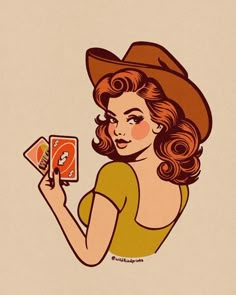 a woman in a cowboy hat holding up a card