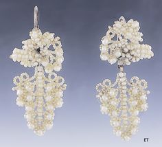 Presented is a lovely pair of Victorian seed pearl bridal earrings. These pieces date to around the 1850-1870 and are of American make. The earrings have 10 karat gold backs, for pierced ears. The earrings consist of seed pearls with larger round pearls sewn onto a mother-of-pearl backing, forming a design of a cluster of grapes. Seed pearl jewelry in this delicate, hand-sewn style was often made and worn specifically as bridal jewelry for a wedding, and this suite would be a lovely addition to Antique Wedding Earrings With Historical Design, Ornate Historical Wedding Earrings, Ornate Historical Design Earrings For Wedding, Vintage Historical Design Earrings For Wedding, Traditional Wedding Earrings With Historical Design, Traditional Earrings With Historical Design For Wedding, Traditional Historical Design Earrings For Wedding, Victorian Wedding Earrings With 17 Jewels, Victorian Earrings For Evening