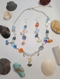 A jewelry set inspired by the sea and beach, with glass and pearls and little sea creatures all through out Under The Sea Accessories, Earrings And Necklace Sets, Ocean Jewelry Aesthetic, Sea Accessories, Crystal Jewelry Diy, Sea And Beach, Earth Style, Sea Jewelry, Ocean Floor