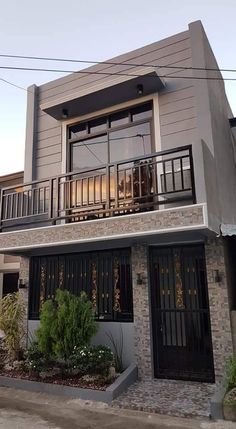 a two story house with balcony and balconies on the second floor is shown