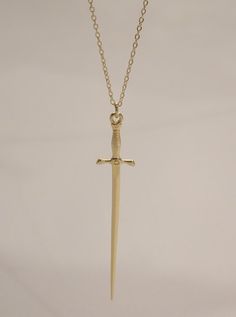 The Silvet Long Dagger Necklace is a must have! This sleek long dagger sword necklace was designed for both men and women and features a lux sword pendant suspended on a diamond cut chain. Bolden your look and pair with these cool pieces! - The Dagger Earrings (available in gold and silver) - The Thin Herringbone Chain Necklace - The Scorpion Necklace Available in 24K gold or rhodium plating over steel Patent plating & sealant technology to ensure durability and long lasting wear Made in Los Ang Granola Goth, Eric Aesthetic, Scorpion Necklace, Ruby Heart Necklace, Knife Necklace, Dagger Necklace, Dagger Earrings, Herringbone Chain, Jewelry Lookbook