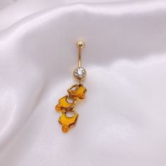 By popular demand I now offer belly rings! I'm so excited to expand to other types of body jewelry in the near future. I make each honeycomb with 18k gold plated stainless steel hexagons and resin resulting in a totally unique and exciting way to to share my love for the bees! Please keep in mind that each piece is handmade and may differ slightly.  The entire barbell and honey piece together measures 2 1/4 inches, or about 55 mm long. Just the dangle piece measures 1 1/4 inch, or about 34 mm. T Belly Button Piercing Jewelry Gold, Unique Belly Rings, Honey Jewelry, Bellybutton Piercings, Belly Button Piercing Jewelry, Belly Button Jewelry, Body Glitter, Belly Button Piercing, Dope Jewelry