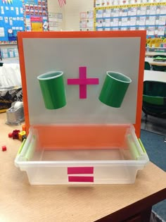 an open box with two cups in it on top of a table at a store