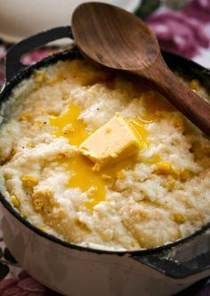 a pot filled with mashed potatoes and butter on top of a floral table cloth