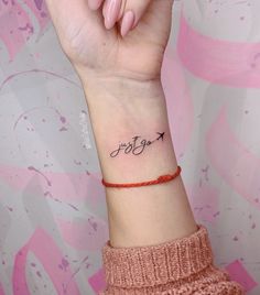 a woman's wrist tattoo with an arrow and the word stay strong on it