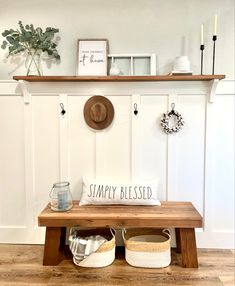 a wooden bench with two baskets underneath it and a sign that says, simply blessed