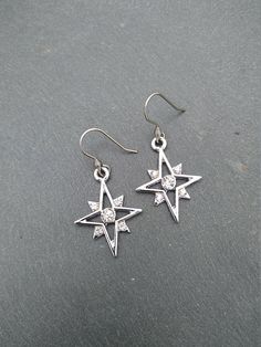 PLEASE read my shop announcement before placing an order so you know what to expect right now. Plus, when ordering from outside Europe, don't forget to provide a phone number for the courier to ensure the fastest and smoothest delivery. Elegant dangle rhinestone starburst earrings, comfortable and lightweight Stainless steel earhooks Stainless steel hooks, won't rust, change its tone or cause you any allergies More Magical celestial jewelry here: https://www.etsy.com/shop/ValkyriesSong?ref=selle Cubic Zirconia Star Charm Dangle Jewelry, Cubic Zirconia Dangle Jewelry With Star Charm, Celestial Silver Earrings With Star Charm, Sparkling Silver Starburst Jewelry, Star-shaped Cubic Zirconia Jewelry With Matching Earrings, Cubic Zirconia Drop Earrings With Star Charm, Pierced Star-shaped Metal Jewelry, Pierced Metal Star Jewelry, Star Charm Metal Drop Earrings