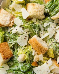 a salad with croutons and parmesan cheese