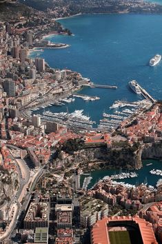 an aerial view of a city with boats in the water