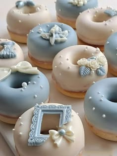 there are many decorated doughnuts on the tray with blue and white frosting