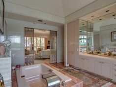 a bath room with a large tub and a mirror on the wall next to it