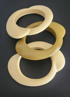 Vintage 60s Mod Bracelets Beige Green Bangles Three, chunky, bangle bracelets - one in olive green and two in cream. They have nubbed, raised curve sections on two sides, giving it an interesting and unusually modernist style. No stamping or markings Condition: very good with a few small little markings here and there on the cream ones. Visible only when pointed out in direct light Diameter of interior 8" Length across 5" Vintage Beige Bracelet, Vintage Handmade Cream Bracelets, Vintage Adjustable Cream Bracelets, Vintage Adjustable Cream Bracelet, Handmade Vintage Cream Bracelets, Vintage Cream Bangle Jewelry, Cream Vintage Bangle Jewelry, Green Bangles, 70s Vibes