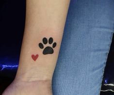 a dog paw with a heart tattoo on the wrist