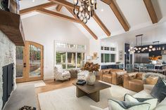 a living room filled with furniture and a fire place in the middle of a room