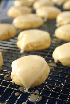 iced cookies on a cooling rack with icing being drizzled over them