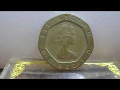 a gold coin sitting on top of a plastic container