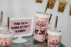 three cups with straws in them sitting on a table next to a sign that says thank you for making my party