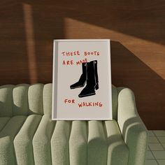 there is a sign that says these boots are mine for walking on the couch next to it