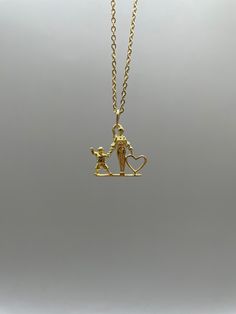 This "Tesoro" necklace is the perfect symbol of the special bond between a mother and son. Made with 10k gold it radiates love and affection. Show your appreciation for a special relationship with this exquisite piece. The gold necklace includes a 10K (18inch) chain. *As this piece is created only by special orders the time frame is 10 to 20 days for processing and delivery. Your delivery tracker will be created where you can check the necessary updates every day. **Note: Pictures are enlarged to show detail. All pendants are packaged and shipped in a cotton baggy inside a water and tear-resistant bubble wrap envelope. If you have any questions about this item or any other items listed in our shop please do not hesitate to contact us.** Completely solid, light, and double-sided. Recommend Chain Silver Necklace, Chain Gold Necklace, Gold Silver Necklace, Gothic Pendant, Mom And Son, Note Pictures, Bell Pendant, Chain Silver, 10k Gold