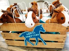 several stuffed horses in a wooden crate with the word horse adoption on it's side