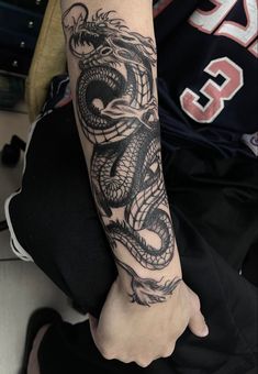 a person with a dragon tattoo on their arm