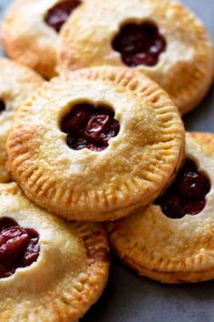 several small pies with cherries on them