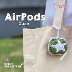 an airpods case is hanging from a tote bag