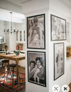 three pictures hanging on the wall above a kitchen table with stools in front of it