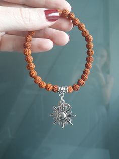 This unique bracelet with divine feminine vibes made of genuine small 5 Mukhi Rudraksha seeds beads and sun & moon charms.  You can wear this sacred beads bracelet in meditation and in your yoga practice, as well as in everyday life. You can wear this bracelet for protection, blessings, good fortune, health and well-being, and for spiritual evolution, or just because you like it :)  ! This bracelet is HANDMADE.  ! My Guru Pilot Babaji granted me the permission and blessing to make jewelry from Rudraksha for other people. ! Rudraksha that I use in my jewelry are high quality beads, real and genuine, from India. SYMBOLISM RUDRAKSHA in Sanskrit means "eye of Shiva" or "tears of Shiva". Rudra is one of the names of the Indian Lord Shiva. Rudraksha is known for its sacred and healing power: hea Hand-strung Hippie Jewelry For Meditation, Hippie Hand-strung Jewelry For Meditation, Symbolic Meditation Bracelet Jewelry, Spiritual Charm Bracelet With 8mm Beads As A Gift, Bohemian Beaded Bracelets For Meditation, Handmade Hippie Bracelets For Meditation, Spiritual Round Beads Bracelets For Meditation, Spiritual Round Beaded Bracelets For Meditation, Spiritual Beaded Bracelets For Meditation