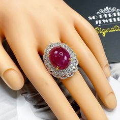 What you see in the pictures, is what you will get! No duplicates or twins! One of a kind EXTREMELY GORGEOUS AND RARE CERTIFIED NO-GLASS-FILLING, GENTLE HEAT ONLY, VIVID RED, BURMESE RUBY RING. This ruby is so rare! At 18.46 carats! Extremely huge! With stunning vivid red color and excellent depth and translucent quality, VS clarity. Rare BURMESE, signature RED Color, EXTREMELY BEAUTIFUL! With SUBSTANTIAL halo of brilliant round, F/VS diamonds. Set in a LUXURIOUS DESIGNED, 18K solid yellow gold Luxury Cabochon Ruby Ring For Anniversary, Formal White Gold Ruby Cabochon Ring, Formal White Gold Cabochon Ruby Ring, Formal Ruby Ring With Diamond And Oval Cabochon Shape, Formal Oval Cabochon Ruby Ring With Diamond, Wedding Ruby Ring With Cabochon, Cabochon Ruby Ring For Wedding, Wedding Ruby Cabochon Ring In Yellow Gold, Burmese Ruby