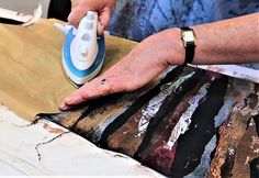 a woman ironing fabric with an electric iron