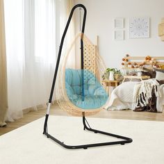 a hammock chair hanging from the ceiling in a living room with white carpet