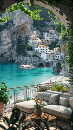 an outdoor area with couches and tables overlooking the water