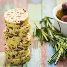 a stack of crackers sitting next to a bowl of olives