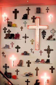 a wall with many crosses and lights on it