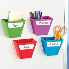 three different colored bins with scissors and markers on them