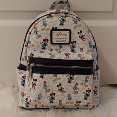 Nwt Price Is Firm Not Accepting Offers Any Offers Will Be Kindly Ignored Or Declined Disney Loungefly Mickey Mouse And Friends Aop Mini Backpack Mickey, Minnie, Donald And Daisy Brand New With Tags Selling As Is New With Tags Approx Size 10 1/2" H X 9" W 5" D This Is The Exact Placement You Will Receive No Price Police/No Rude Comments No Trades/No Holds All Items Are Always Triple Protect Before Mailing Out And Pics Are Taken During Packaging And Recorded Smoke Free Home Always Drama Free Zone Daisy Brand, Disney Purse, Loungefly Bag, Mickey Mouse And Friends, Disney Merchandise, Mini Backpack, Bag Lady, Backpacks, Black And White