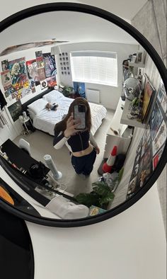 a woman is taking a selfie in the mirror with her cell phone and looking at herself