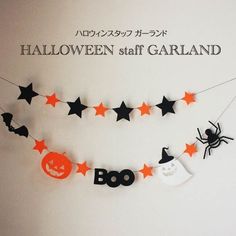 halloween decorations hanging on the wall with black and orange stars