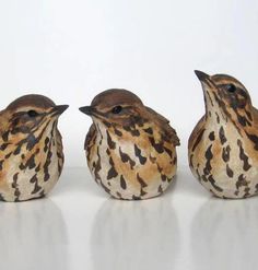 three ceramic birds sitting next to each other