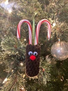 a christmas ornament with candy canes in the shape of a reindeer head