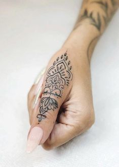 a woman's hand with a tattoo on it