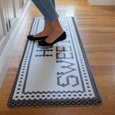 a woman in high heels standing on a rug