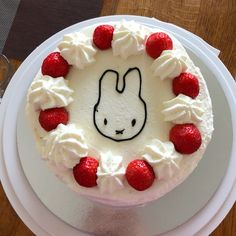 a cake decorated with white frosting and strawberries