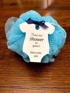 a blue baby shower ball with a tag on it that says, from our shower to yours