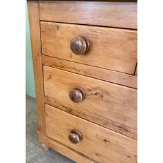 a wooden dresser with metal knobs on it's handles and drawer drawers in a room