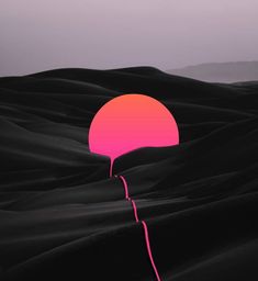 a pink balloon floating in the middle of a desert