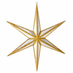 a gold and white star ornament hanging from a string